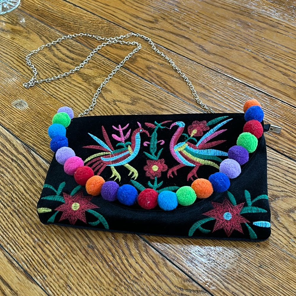 Black velour shoulder bag, chain strap, embroidered and pompom details.